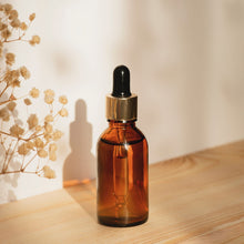 Load image into Gallery viewer, Truth Cosmetics bakuchiol and rose geranium facial oil in a glass dropper bottle on a wooden surface