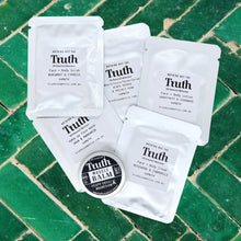 Load image into Gallery viewer, Truth Cosmetics sample sachets and small balm on green tiles hydrating face and body lotion with free sample
