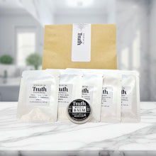 Load image into Gallery viewer, Truth Cosmetics sample kit with sachets and balm on marble table hydrating face and body lotion with free sample