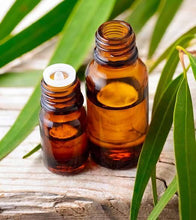 Load image into Gallery viewer, Truth Cosmetics1 anti-microbial essential oil blend in amber glass bottles with eucalyptus leaves on wood