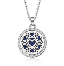 Load image into Gallery viewer, Truth Cosmetics1 silver heart filigree pendant aromatherapy diffuser jewellery with blue pad and crystal rim