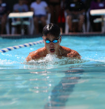 Load image into Gallery viewer, Competitive swimmer in pool with Truth Cosmetics natural swimmers shampoo vegan for chlorine care