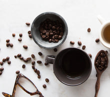 Load image into Gallery viewer, Truth Cosmetics vegan face wash flatlay with coffee beans bowls mugs spoon and glasses on white marble surface