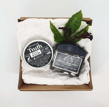 Load image into Gallery viewer, Truth Cosmetics vegan muscle balm gift set with muscle balm tin charcoal soap bar and decorative greens in kraft box