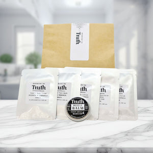 Truth Cosmetics sample kit with sachets and balm on marble table hydrating face and body lotion with free sample