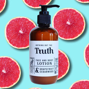 Truth Cosmetics grapefruit cedarwood lotion in amber pump bottle on grapefruit background vegan lotion with free sample offer