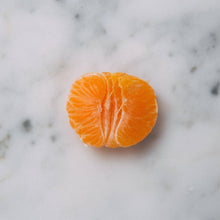 Load image into Gallery viewer, Truth Cosmetics1 java and mandarin face wash displayed with fresh mandarin slice on marble suggesting citrus brightening cleanser

