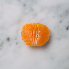 Load image into Gallery viewer, Truth Cosmetics1 vegan face wash concept shown with peeled mandarin half on white marble background
